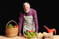 Mature farmer going to cook healthy dish with fresh vegetables and eggs