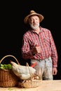 Mature farmer picked up fresh vegetables and eggs, going to sell it to restaurant