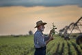 Farmer in front of irrigation system in field Royalty Free Stock Photo
