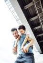 Mature father with his son under the bridge having fun together Royalty Free Stock Photo