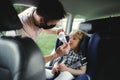 Father with small son going on trip by car, wearing face masks. Royalty Free Stock Photo