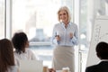 Mature female business coach speaking at team meeting training s Royalty Free Stock Photo