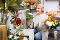 Mature female customer in floral shop Royalty Free Stock Photo