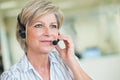 mature female customer-services worker wearing headset Royalty Free Stock Photo