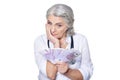 Mature female doctor with money posing on white background Royalty Free Stock Photo