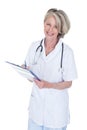 Mature female doctor writing on clipboard Royalty Free Stock Photo