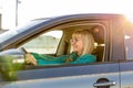 Mature female driver smiling behind the wheel Royalty Free Stock Photo