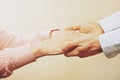 Mature female in elderly care facility gets help from hospital personnel nurse. Close up of aged wrinkled hands of senior woman. G Royalty Free Stock Photo