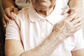 Close up of mature womans & nurse hands. Health care giving, nursing home. Parental love of grandmother. Old age related diseases. Royalty Free Stock Photo