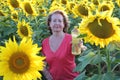 Mature female farmer holding sunflower oil bottle Royalty Free Stock Photo