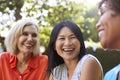 Mature Female Friends Socializing In Backyard Together Royalty Free Stock Photo