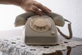 mature female hand removing Handset, rotating Dialer on Old white Rotary Telephone with Disc Dial with finger, putting retro phone