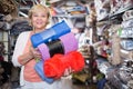 Mature female purchaser holding cotton plaids