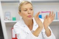 mature female scientist working in light laboratory