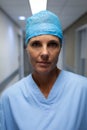 Mature female surgeon standing in hospital corridor Royalty Free Stock Photo