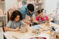 Mature teacher working with group of kids in pottery workshop Royalty Free Stock Photo