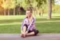 Mature fitness woman tie sport shoelaces in park