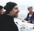 Mature friends drinking wine at the beach Royalty Free Stock Photo