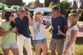 Mature Friends Enjoying Drinks At Summer Garden Fete Royalty Free Stock Photo