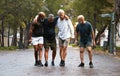 Mature, friends and fitness pain with men helping friend after injury while training in nature for wellness and health