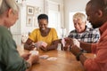 Mature friends playing cards at home Royalty Free Stock Photo