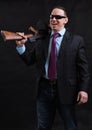 Mature gangster in sunglasses dressed in suit with tommy gun Royalty Free Stock Photo