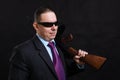 Mature gangster in sunglasses dressed in suit with tommy gun Royalty Free Stock Photo