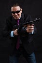 Mature gangster in sunglasses dressed in suit with tommy gun Royalty Free Stock Photo