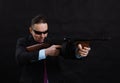 Mature gangster in sunglasses dressed in suit with tommy gun Royalty Free Stock Photo
