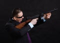 Mature gangster in sunglasses dressed in suit with tommy gun Royalty Free Stock Photo