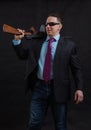 Mature gangster in sunglasses dressed in suit with tommy gun Royalty Free Stock Photo