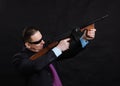 Mature gangster in sunglasses dressed in suit with tommy gun Royalty Free Stock Photo