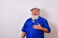 Mature gentleman with a white fedora hat, blue guayabera shirt, and bolo tie on a white background