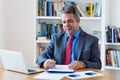 Mature german businessman working at desk Royalty Free Stock Photo