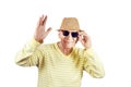 Mature granddad wearing hat and sunglasses waving with hand