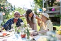 Mature granddaughter talking with grandparents, reunite after a long time. Family gathering at garden party. Royalty Free Stock Photo