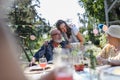Mature granddaughter talking with grandparents, reunite after a long time. Family gathering at garden party. Royalty Free Stock Photo