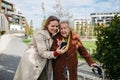 Mature granddaughter teaching grandmother how to use smartphone. Caregiver helping senior lady shopping online on Royalty Free Stock Photo