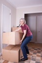 Mature woman stacks big brown boxes