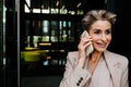 Mature grey woman smiling while talking on mobile phone