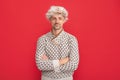 mature guy portrait. positive man in earflap hat. grizzled guy in sweater on red background. Royalty Free Stock Photo