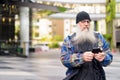 Mature handsome bearded man using phone in the city streets outdoors Royalty Free Stock Photo