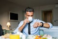 Mature businessman having breakfast in a hotel room. Royalty Free Stock Photo