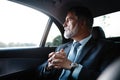 Mature handsome businessman is sitting in luxury car. Serious bearded man in suit. Royalty Free Stock Photo