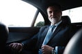 Mature handsome businessman is sitting in luxury car. Serious bearded man in suit. Royalty Free Stock Photo