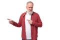 mature handsome gray-haired man with a beard points a finger to the side on a white background Royalty Free Stock Photo