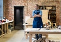 Mature handsome joiner work in carpentry. He is successful entrepreneur at his workplace. Royalty Free Stock Photo