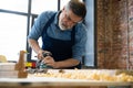 Mature handsome joiner work in carpentry. He is successful entrepreneur at his workplace. Royalty Free Stock Photo