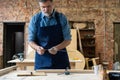 Mature handsome joiner work in carpentry. He is successful entrepreneur at his workplace. Royalty Free Stock Photo