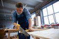 Mature handsome joiner work in carpentry. He is successful entrepreneur at his workplace. Royalty Free Stock Photo